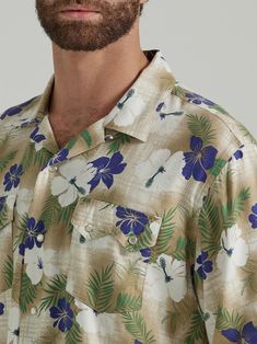 VACATION MODE COWBOY Casual and carefree, Wrangler’s Coconut Cowboy snap-front camp shirt looks to the rich textures and colors in the world around us for inspiration. Taking cue from the classic Hawaiian shirt, this beachside button-up comes with a traditional spread collar, two snap flap pockets, a straight hem, and a bold tropical print with traces of our western roots throughout. It’s crafted from a lightweight cotton blend to keep you comfortable in the warm days ahead. Finish the look with Cowboy Casual, Hibiscus Print, Tan Shirt, Cowboy Shirt, Wrangler Shirts, Cowboys Shirt, Camp Shirt, Vacation Mode, Wrangler Jeans