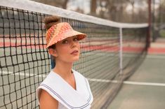 The Clementine in red is made for the lighthearted, the colorful, and the happy. She's useful just as much as she is stylish. This straw visor keeps the sun out of your eyes on the beach, playing tennis, or lounging by the pool. The Panama straw is woven from natural toquilla straw grown in Ecuador and woven by a single weaver each time, which takes several hours to complete. The straw is then shipped to the US and blocked in the US. The tie closure is made with ribbon. Summer Red Visor Hats, Fun Summer Visor Sun Hat, Red Visor Hats For Summer, Casual Summer Tennis Hat, Playful Summer Visor Hat, Adjustable Summer Tennis Hat, Adjustable Tennis Hats For Summer, Straw Visor, Playing Tennis