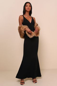 a woman wearing a black dress and fur stole