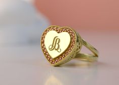 Introducing our stunning Custom Monogram Gold Colours Stone Ring with Heart design! This elegant ring features a beautiful combination of gold tones and a personalized monogram, making it the perfect accessory for adding a touch of sophistication to any outfit. The delicate heart-shaped stone adds a touch of romance and sentimentality to this unique piece. Handcrafted with care and attention to detail, this ring is a must-have for anyone looking to add a personalized touch to their jewelry colle Ring With Heart, Colored Stone Rings, Gold Monogram, Elegant Ring, Personalized Monogram, Custom Monogram, Stone Ring, Heart Design, Stone Rings