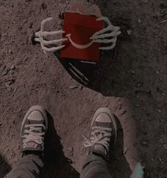 a person standing next to a red bag on the ground