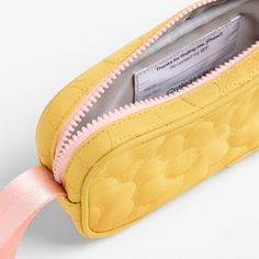 A fun pencil case that's built to handle all the thrills of the day. A pattern of quilted blooms add sunny vibes to the yellow exterior, and the contrasting pink zipper, zipper pull and loop handle give it the perfect finish. Constructed of supremely durable polyester fabric that includes recycled plastic bottles, our roomy, easy-clean case makes it simple to keep all their pens and pencils organized and accessible. Pair with the Quilted Yellow Flower lunch box and matching backpack for a totall Yellow Rectangular Pencil Case For Travel, Yellow Pencil Case With Pen Holders For Everyday Use, Yellow Pencil Case For Everyday Use, Affordable Yellow Pencil Case With Zipper, Yellow Pouch Pencil Case For Travel, Functional Pink Pencil Case With Zipper, Cheap Yellow Pouch Pencil Case, Yellow Travel Pencil Pouch, Yellow Travel Pencil Case Pouch