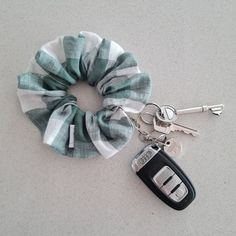 a hair scrunch tied around a car key chain with two keys attached to it