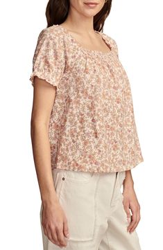 A cascading pattern of earthy flowers enlivens this all-cotton peasant top cut in a lightweight, flowy silhouette with smocked detail at the front and back. Square neck Short sleeves 100% cotton Machine wash, tumble dry Imported Feminine Flowy Smocked Top With Floral Print, Flowy Smocked Casual Tops, Casual Flowy Smocked Top, Casual Smock Top Flowy Fit, Casual Flowy Smock Top, Feminine Cotton Peasant Top For Spring, Flowy Casual Tops With Boho Print, Flowy Boho Print Casual Tops, Casual Flowy Tops With Boho Print