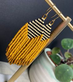 Pretty and bold beaded earrings!  A striped top with light cream and black beads nestles next to a waterfall of mustard seed beads  The mustard beads give beautiful movement and life to this fun pair All beads are Miyuki brand - known for their quality and durability. They are also lightweight, keeping this pair light and easy to wear Hooks are locally sourced and are gold plated nickel free  Earrings measure 3" from top of hook to bottom bead Every pair of earrings are hand made by me with love Affordable Yellow Beaded Earrings For Summer, Handwoven Yellow Beaded Earrings With Round Beads, Yellow Handwoven Beaded Earrings With Round Beads, Yellow Beaded Earrings With Black Beads, Handmade Earrings Beaded, Nickel Free Earrings, Fall Earrings, Gold Moon, Free Earrings