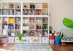 a child's room with bookshelves and toys