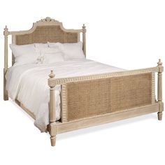 a white bed with wicker headboard and foot board in front of a white background