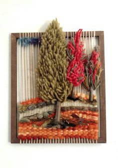 an art piece made out of yarn with trees on it