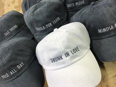 six hats with the words drunk in love written on them sitting next to each other