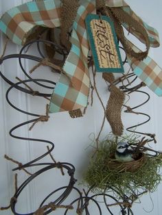 a door hanger with a bird's nest and ribbon on the front door