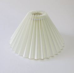 a white lamp shade sitting on top of a table