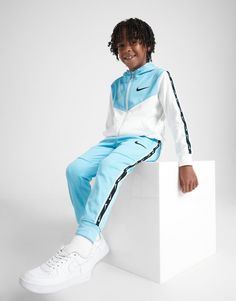 Get them an upgrade in this children's Tape Poly Full Zip Tracksuit from Nike. In a Blue and White colourway, this tracksuit is made from a smooth and lightweight poly fabric to keep your kiddo comfy. It features a full zip hoodie for custom coverage, ribbed trims to hold the shape, and split pouch pocket for storage. The matching track pants have an elastic waistband and cuffed ankles to hold the shape. Signed off with Nike branding throughout. Nike React Vision, 270 Nike, Nike Branding, Leggings Hoodie, Childrens Clothing, Nike Brand, Blue Nike, Jd Sports, Adidas Nike