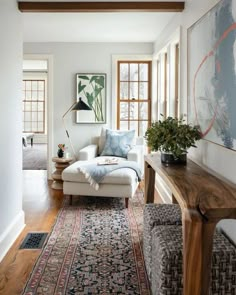 a living room filled with furniture and lots of windows