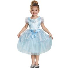 Your little princess will enchant the whole court in her Cinderella Halloween costume. This elegant dress has a glittering stagecoach design with a blue ribbon waist featuring a gold framed cameo of Cinderella. The sparkling tea-length skirt in powder blue is the perfect princess attire. Watch her twirl the night away as she goes in search of some Halloween magic! Her fairy godmother couldn't have created a lovelier gown. This Cinderella dress is a perfect fairytale costume for girls. Toddler Cinderella Costume, Disney Kızları, Cinderella Dress Costume, Cinderella Halloween Costume, Cinderella Dress Disney, Costume Toddler, Classic Halloween Costumes, Blue Satin Dress, Cinderella Dress