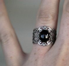 Victorian style sterling plate silver ox filigree ring measuring 18mm wide at the widest point and fully adjustable. Also available in antiqued brass. In the center is a 10x8mm oval black onyx cabochon. Black Onyx Metaphysical Properties Black onyx has been associated with regeneration and new beginnings. Black onyx is thought by some to have protective qualities, making it advantageous to carry when traveling. It is said to be useful in fighting basic fears and helping to move beyond bad relati Funky Jewellery, Gothic Rings, Black Onyx Stone, Ring Black, Filigree Ring, Onyx Stone, Pretty Jewellery, Frankenstein, Black Rings