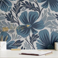 a blue and white floral wallpaper with the word happy written on it in gold