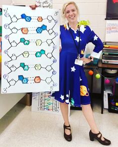 a woman standing in front of a poster