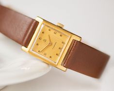 "Square wristwatch \"ZARIA\", a pre-owned vintage timepiece, a model with 17 jewels. Watch is in fully working order and professionally serviced. Mechanical movement, manual winding. The brand new genuine leather band is included. Year: 80s The case measures 0.78\" (2 cm) by 0.78\" (2 cm). Thanks for checking out my listing, let me know if you have any other questions. Express shipping worldwide is available. Just look at my shop shipping profile upgrades.  Please have a look at other vintage la Vintage Rectangular Watch For Everyday, Vintage Rectangular Everyday Watch, Vintage Everyday Rectangular Watch, Everyday Vintage Rectangular Watch, Vintage Rectangular Watch With Leather Strap, 80s Fashion Women, Wristwatch Vintage, Water Resistant Watch, Vintage Watches Women