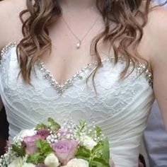 a woman in a wedding dress holding a bouquet