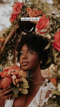 a woman with flowers in her hair holding a bouquet