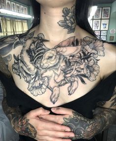 a woman with tattoos on her chest and arms