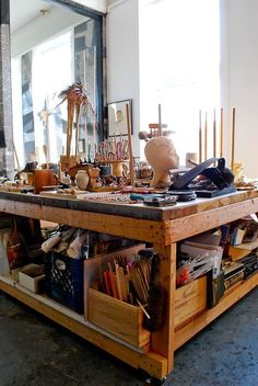 a table with many items on it in front of a mirror and other things inside