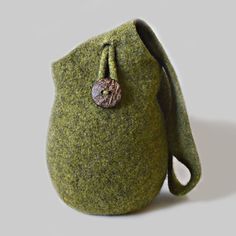 a small green bag with a button on it