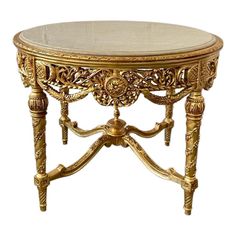 This center table is the perfect piece to add glitz, glam and luxury to an entryway. The gold finish on this piece is beautifully paired with a beige marble top that adds the perfect touch of elegance.   This table features an intricate floral beauty of baroque carvings and delicate curved legs.  Dimension: 31.5"H x 42.5" Diameter. Table Gogogne, French Parisian Kitchen, Coffee Table Wedding, Antique Coffee Table, Parisian Kitchen, Candy Pastel, Royal Table, Antique Coffee Tables, French Baroque