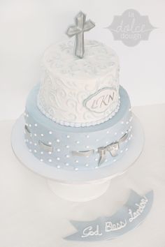 a blue and white cake with a cross on top