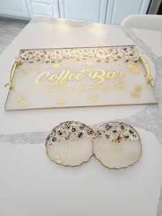 there are two cookies sitting on the table next to each other, and one is decorated with gold foil