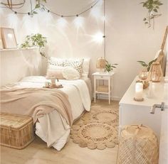 a bedroom with white walls and wooden flooring is decorated in neutral tones, including wicker baskets