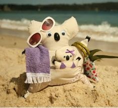 two stuffed animals sitting on top of a sandy beach next to the ocean with text overlay that reads easy to sew