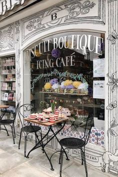 an image of a store front with cakes and cupcakes on the table outside