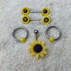 three pairs of sunflowers are on the floor next to two hooks and balls