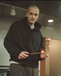 a man holding a lit match in his hand