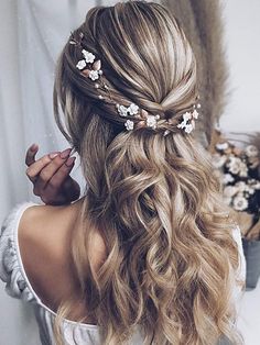 a woman with long blonde hair and flowers in her hair