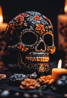 a decorated skull with candles in the background