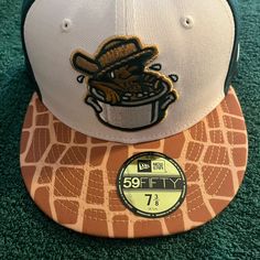 a hat with a patch on the front and an image of a giraffe eating out of a bowl