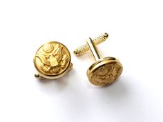 This cufflink set bears authentic United States Army uniform buttons set on your choice of gold-tone or silver-tone cufflink hardware. Each button was manufactured by the Waterbury Button Company, the official supplier of the United States Military. This set will be hand-crafted to order by a military spouse at Hope Design Ltd.Ⓡ. Cufflink measurements: 5/8 x 5/8 x 3/4" United States Army Uniform, Gold Cuff Links, Hope Design, United States Military, Military Spouse, Indian Jewelry Sets, Army Uniform, Gold Cufflinks, West Point