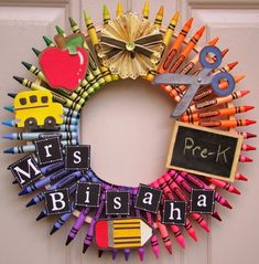 a wreath made out of crayons and school supplies