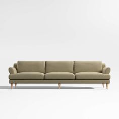 a beige couch sitting on top of a white floor