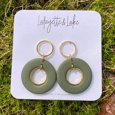 the earrings are made from green plastic and gold hoops, with an oval design on each