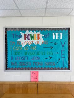 a bulletin board on the wall in a classroom with words and phrases written below it