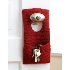 a red bag with keys hanging from it's side and a key holder attached to the door