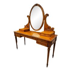 an antique wooden dressing table with mirror on it's top and drawer underneath the vanity