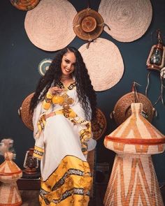 The beauty of Ethiopian traditional dress is truly a sight to behold, and the stunning yellow color of this particular garment is simply breathtaking. The dress features a flowing silhouette that drapes elegantly over the body, with intricate embroidery and beading adding texture and dimension to the fabric. The yellow color of the dress is bright and vibrant, evoking images of sunshine and warmth. As the wearer moves, the dress catches the light and shimmers, creating a truly mesmerizing effect Yellow Kaftan For Wedding And Festivals, Yellow Traditional Drape Gown, Traditional Yellow Wedding Kaftan, Yellow Dress With Gold Embroidery For Festivals, Yellow Dresses With Gold Embroidery For Festivals, Traditional Yellow Floor-length Dress, Traditional Yellow Gown, Gold Dresses With Traditional Patterns For Ceremonies, Gold Dresses For Traditional Festivals