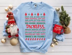 a blue sweatshirt with christmas sayings on it