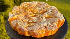 an orange cake sitting on top of a black plate