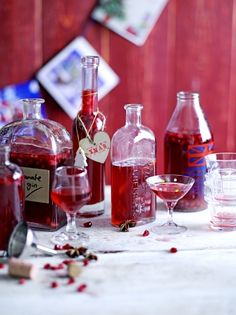 several bottles and glasses filled with liquid on a table