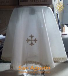 a white table cloth with a cross on it